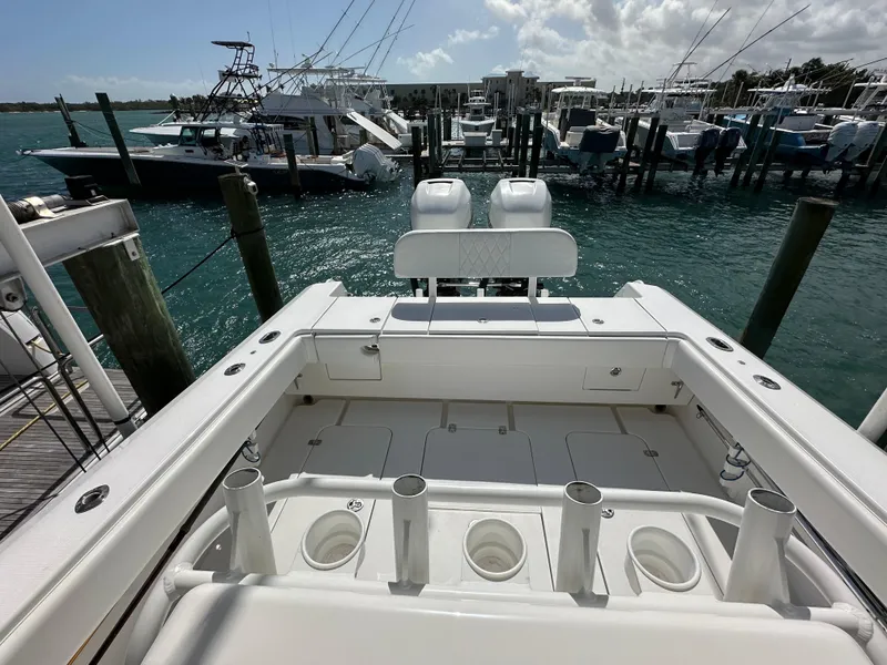 Slide: The Image of 2006 Island Runner 35 boat docked at marina, featuring spacious deck and rod holders. - 19