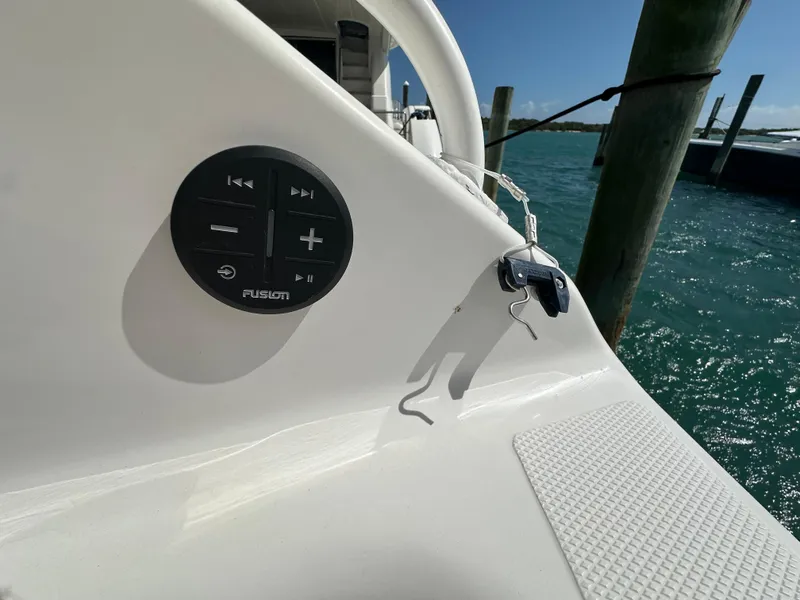 Slide: The Image of Island Runner 35 boat dashboard with audio controls, docked by the water, 2006 model. - 24
