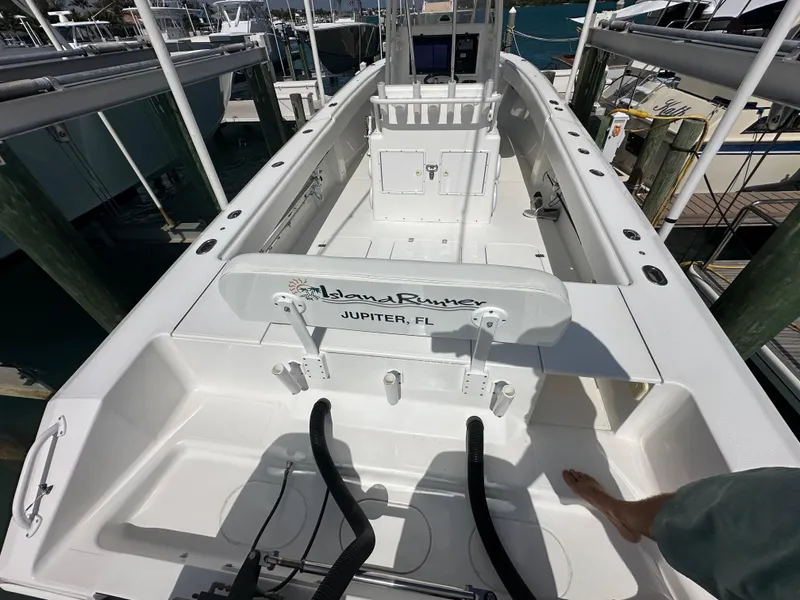 Slide: The Image of 2006 Island Runner 35 boat interior, docked in Jupiter, FL, showcasing spacious deck layout. - 25