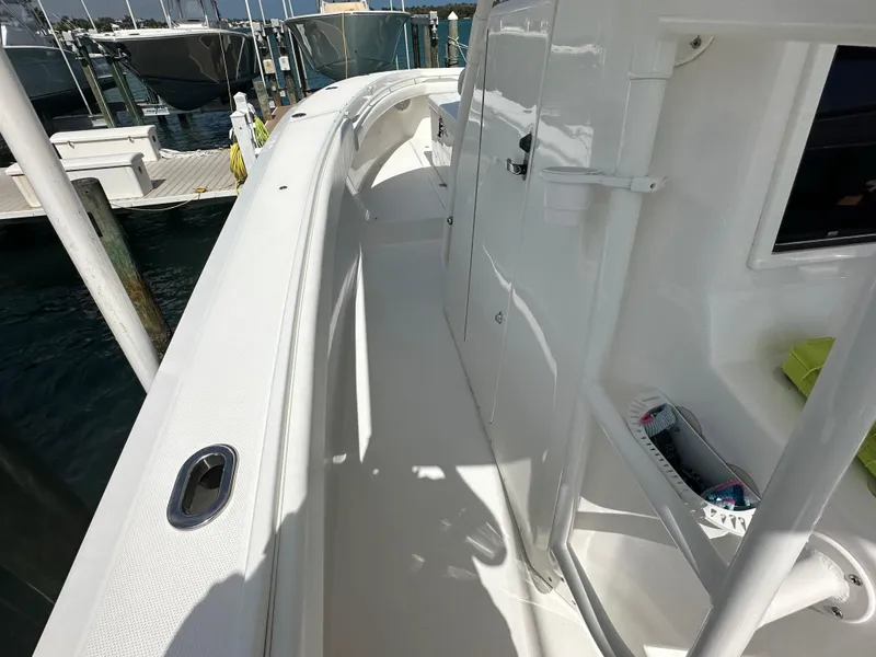 Slide: The Image of 2006 Island Runner 35 boat deck with sleek white finish and docked marina view. - 32