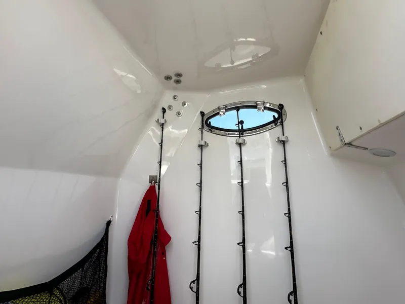 Slide: The Image of Interior of 2006 Island Runner 35 boat with fishing rods and porthole. - 37