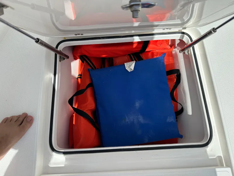 Slide: The Image of Storage compartment on a 2006 Island Runner 35 boat with life jackets. - 38