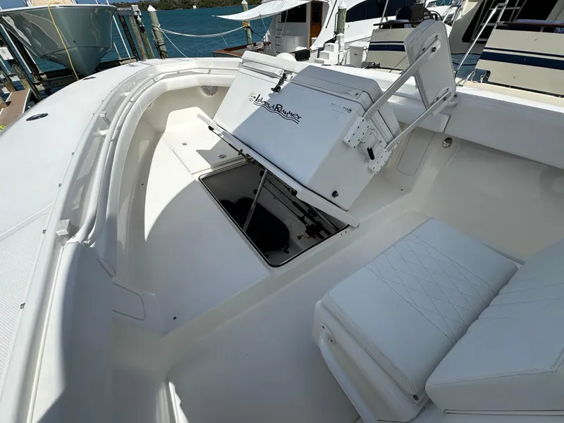 Slide: The Image of 2006 Island Runner 35 boat interior with seating and storage compartment. - 39
