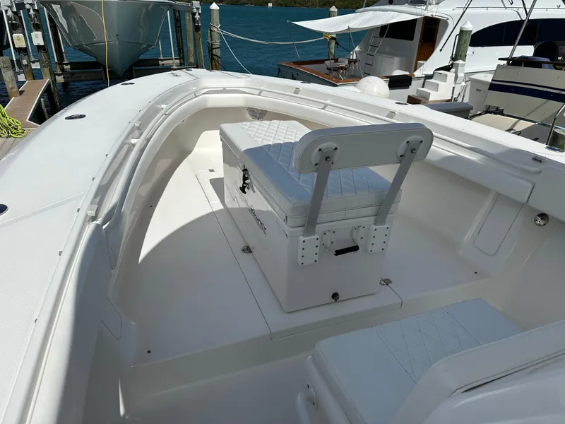 Slide: The Image of 2006 Island Runner 35 boat interior with seating and storage, docked at marina. - 44
