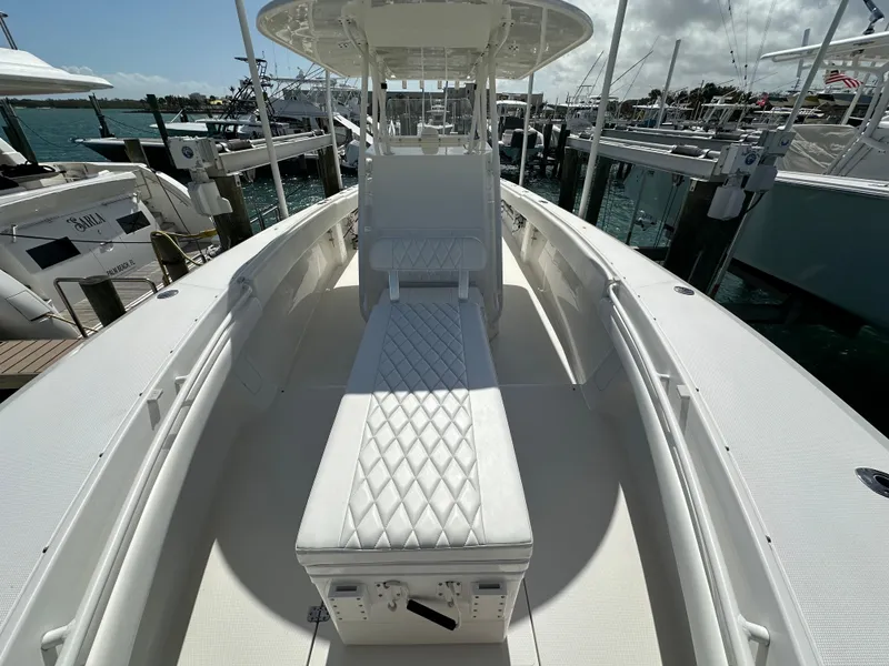 Slide: The Image of 2006 Island Runner 35 boat with white seating and sleek design at a marina. - 47
