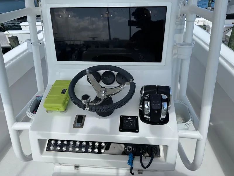 Slide: The Image of Control console of a 2006 Island Runner 35 boat with steering wheel and throttle. - 7