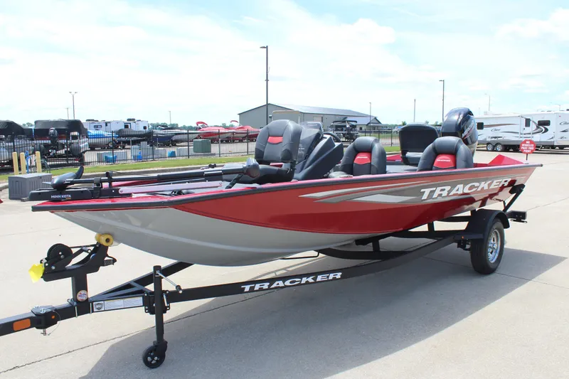 Slide: The Image of 2025 Tracker Pro Team 175 boat on trailer, red and gray design, parked outdoors. - 3