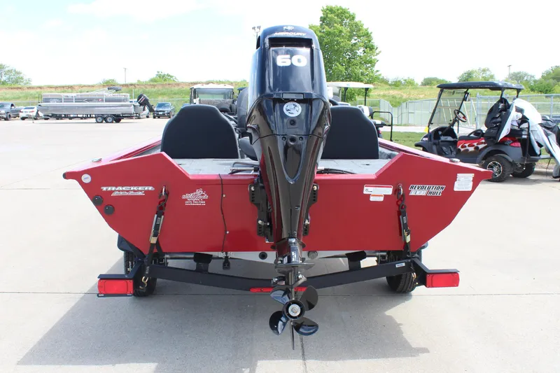 Slide: The Image of 2025 Tracker Pro Team 175 boat, rear view, red color, parked outdoors. - 6