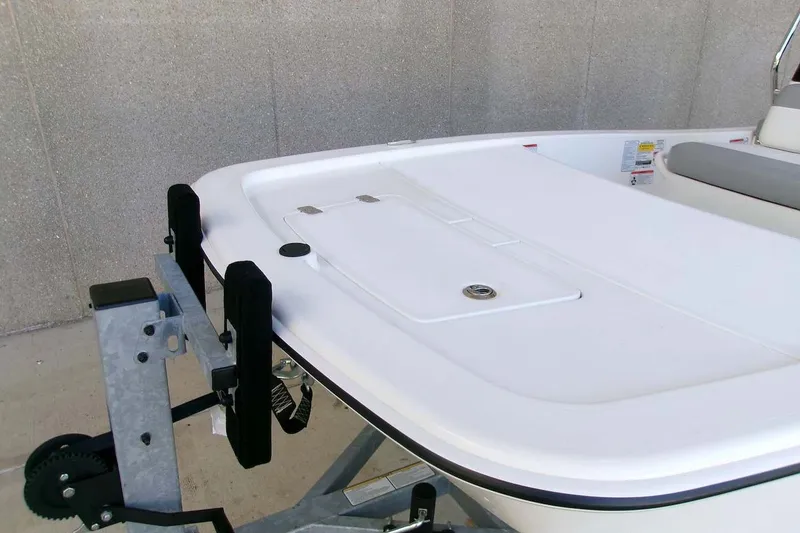 Slide: The Image of 2025 Mako Pro Skiff 13 CC boat on trailer, featuring sleek white deck design. - 7
