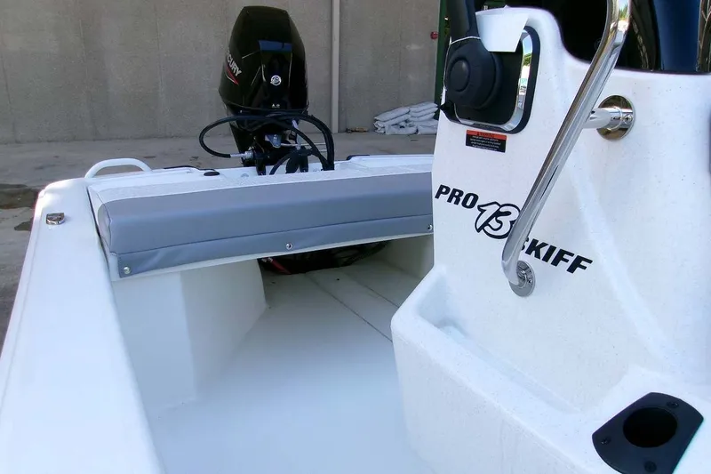 Slide: The Image of 2025 Mako Pro Skiff 13 CC boat interior with motor and seating. - 8