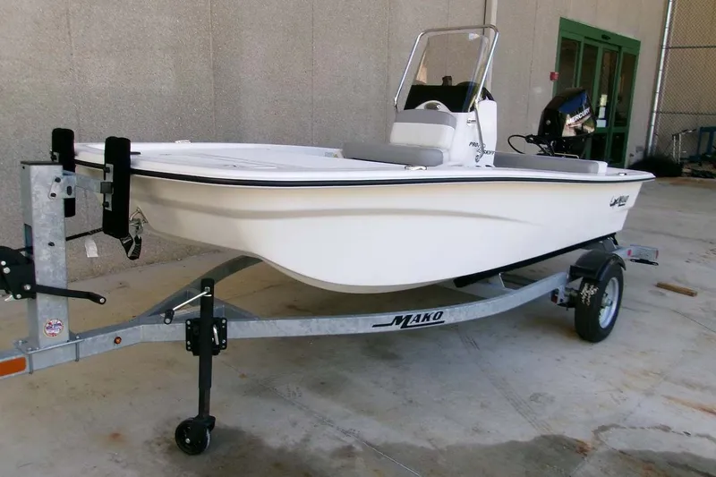 Slide: The Image of 2025 Mako Pro Skiff 13 CC boat on trailer, parked outdoors. - 1