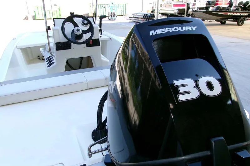 Slide: The Image of 2025 Mako Pro Skiff 13 CC with Mercury 30 outboard engine, featuring sleek design and controls. - 9