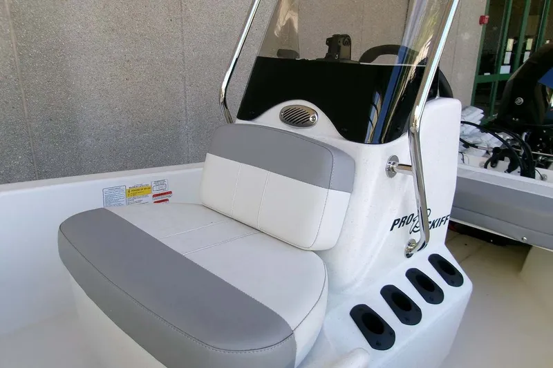 Slide: The Image of 2025 Mako Pro Skiff 13 CC boat seat with console and rod holders. - 6