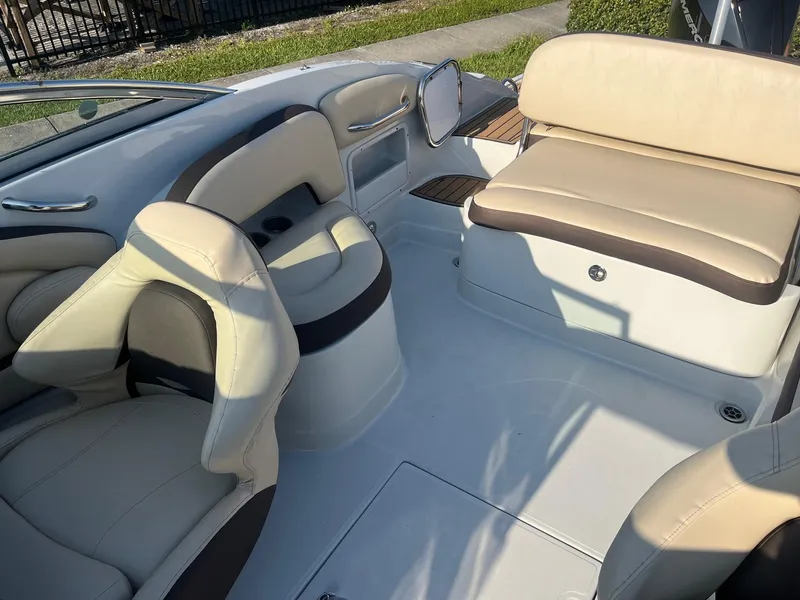 Slide: The Image of 2022 Crownline 260 XSS boat interior with beige and brown seating. - 10