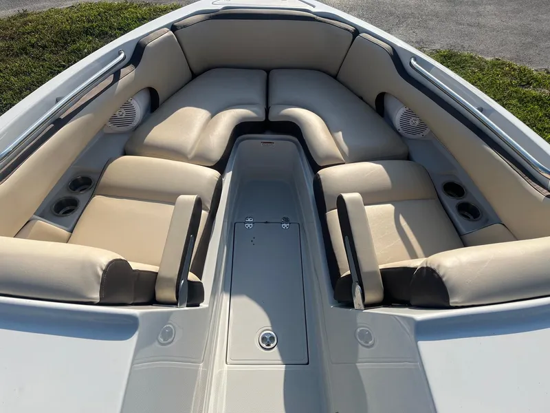 Slide: The Image of 2022 Crownline 260 XSS boat interior with beige seating and cup holders. - 11