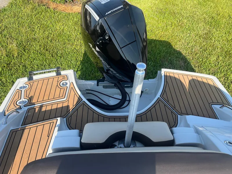 Slide: The Image of 2022 Crownline 260 XSS boat with teak deck and Mercury outboard motor. - 13