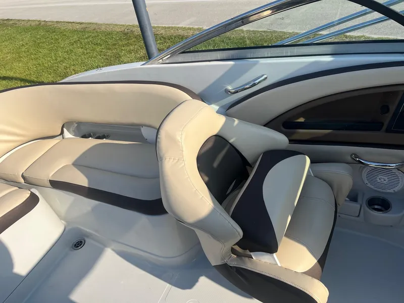 Slide: The Image of 2022 Crownline 260 XSS boat interior with beige and black seating. - 9