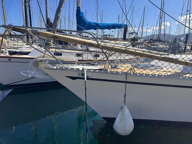 Slide: The Image of Sailboat Whiting 40, 1985 model, docked in marina with clear blue sky. - 1