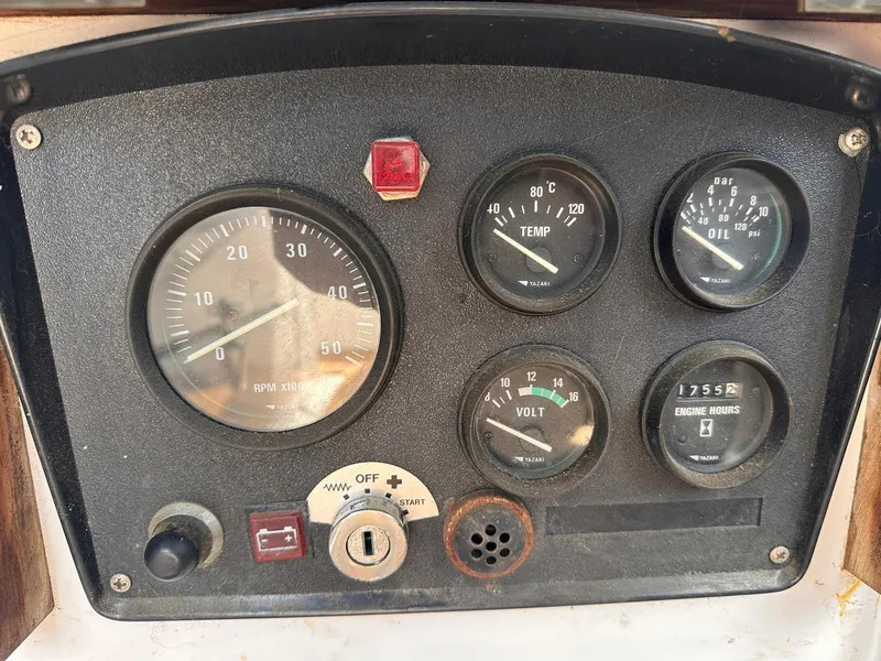 Slide: The Image of Control panel of a 1985 Whiting 40 boat with gauges and switches. - 11