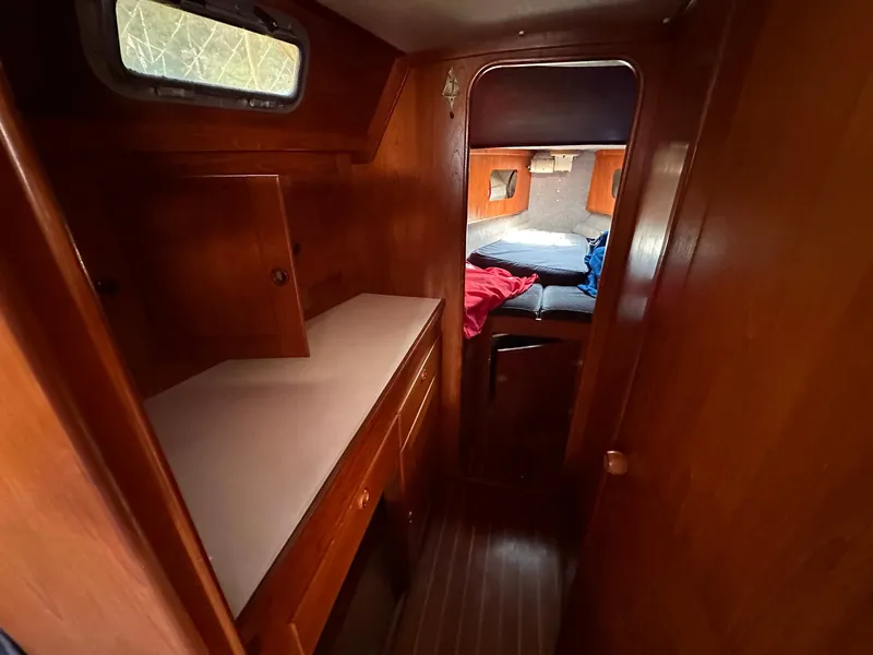 Slide: The Image of 1985 Whiting 40 yacht interior with wooden cabinetry and cozy sleeping quarters. - 21