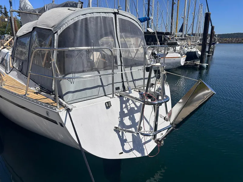 Slide: The Image of Sailboat Whiting 40, 1985 model, docked in a marina with clear blue skies. - 6