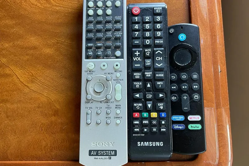 Slide: The Image of Three remote controls on a wooden surface, including Sony and Samsung models. - 15