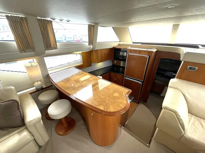 Slide: The Image of Luxurious interior of 2006 Carver 466 Motor Yacht with elegant wood finishes and comfortable seating. - 17