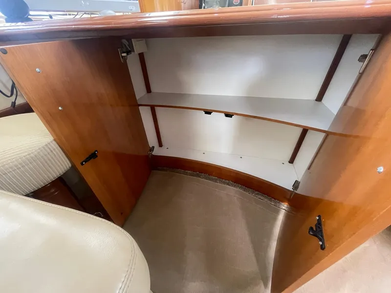 Slide: The Image of Open cabinet inside 2006 Carver 46 Motor Yacht, featuring wooden finish and shelving. - 18