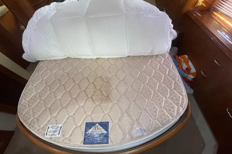 Slide: The Image of Bed in 2006 Carver 46 Motor Yacht cabin with quilted mattress and white bedding. - 38