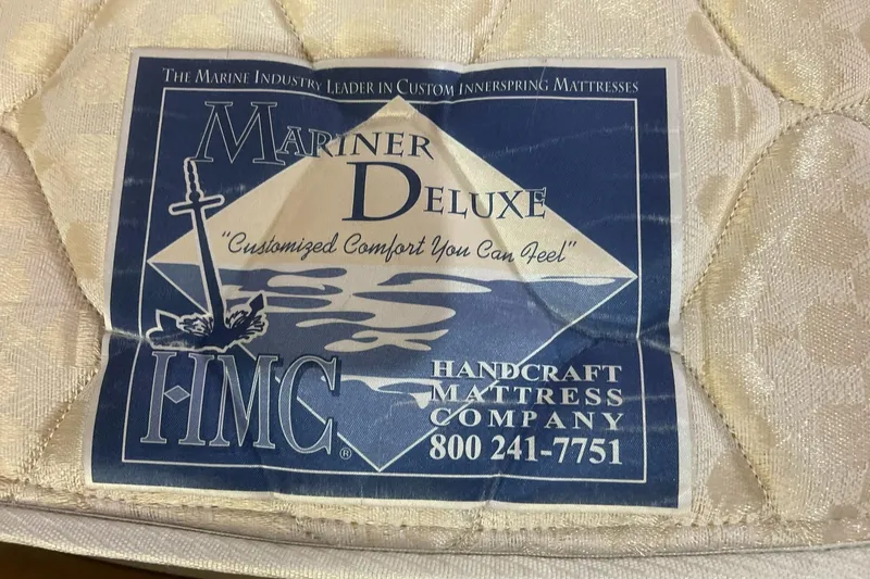 Slide: The Image of Label on Mariner Deluxe mattress by Handcraft Mattress Company, featuring nautical design and contact information. - 39