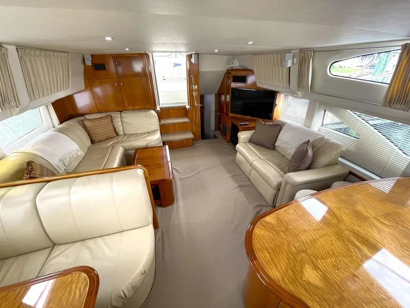 Slide: The Image of Luxurious interior of 2006 Carver 466 Motor Yacht with plush seating and wood finishes. - 4