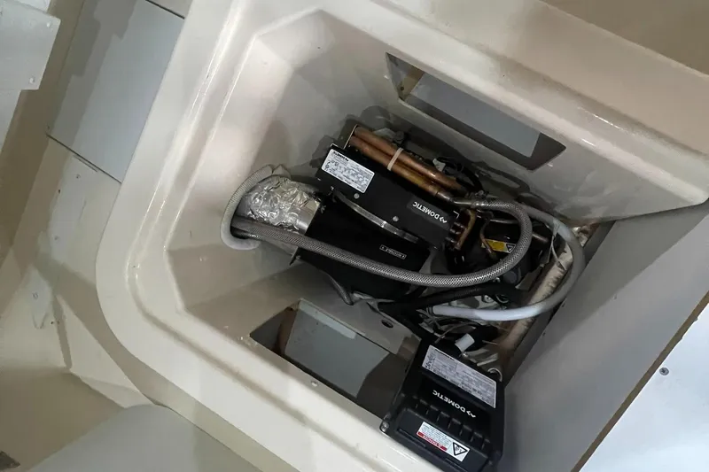 Slide: The Image of Engine compartment of a 2006 Carver 46 Motor Yacht, showcasing mechanical components and wiring. - 41