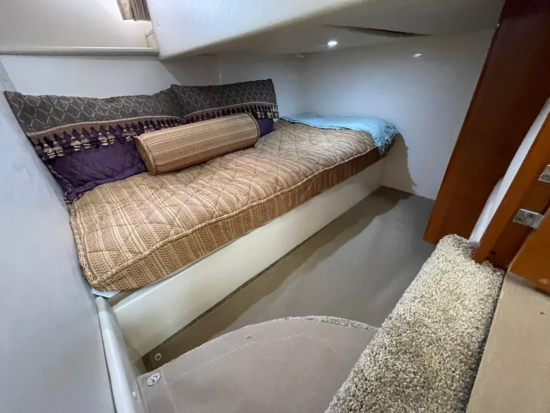 Slide: The Image of 2006 Carver 466 Motor Yacht interior cabin with cozy bed and cushions. - 58