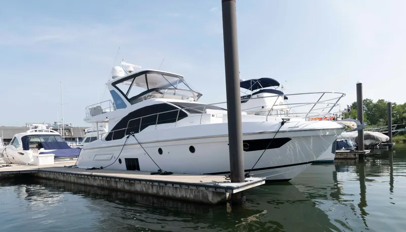 Slide: The Image of Azimut Fly 50 yacht, 2022 model, docked at a marina on a sunny day. - 1