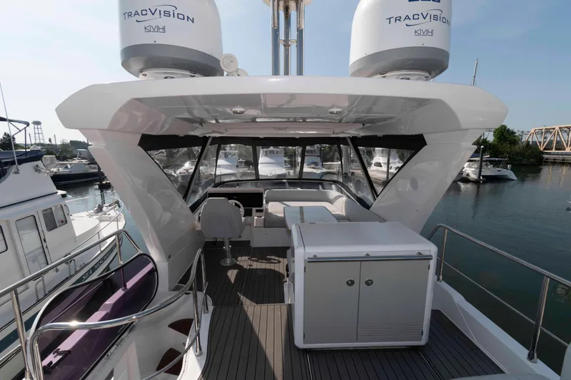 Slide: The Image of 2022 Azimut Fly 50 yacht flybridge with seating and navigation equipment, docked in a marina. - 10