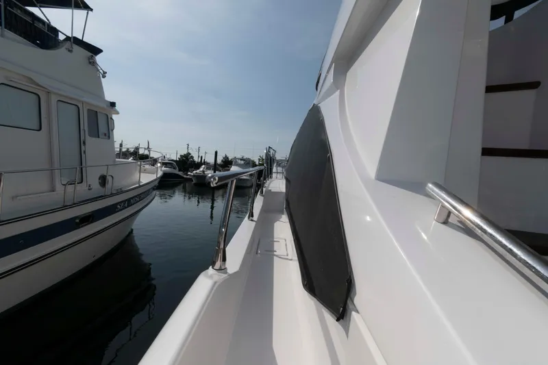 Slide: The Image of 2022 Azimut Fly 50 yacht docked at marina, side view with railing. - 19
