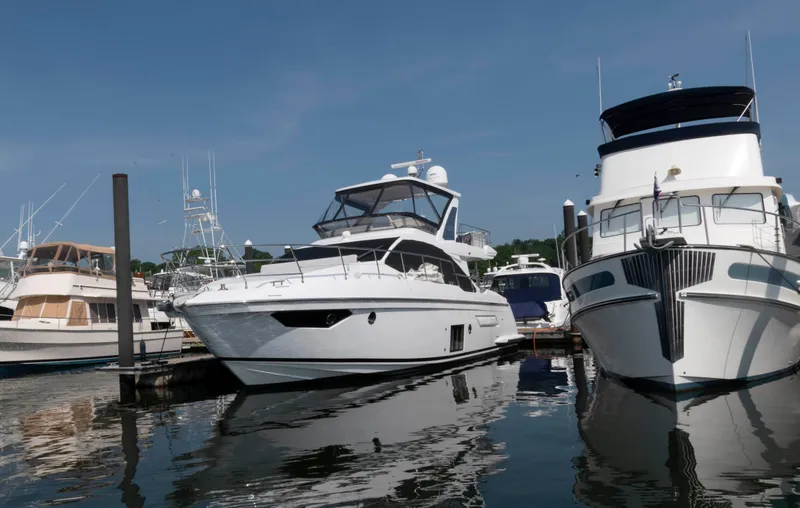 Slide: The Image of 2022 Azimut Fly 50 yacht docked at marina, surrounded by other boats. - 2