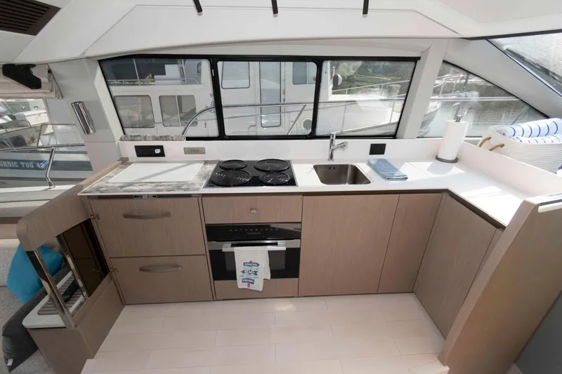 Slide: The Image of Modern kitchen interior on 2022 Azimut Fly 50 yacht, featuring sleek cabinetry and appliances. - 27