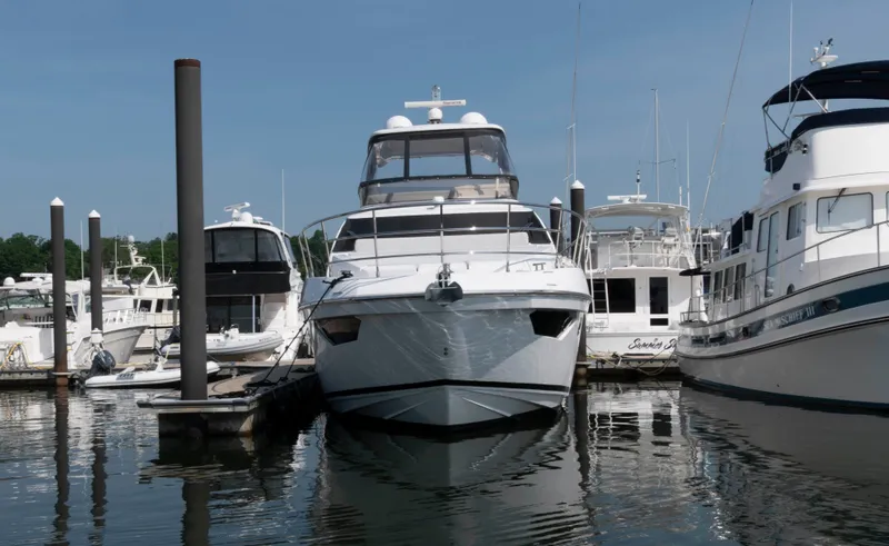 Slide: The Image of 2022 Azimut Fly 50 yacht docked at marina, surrounded by other boats. - 3
