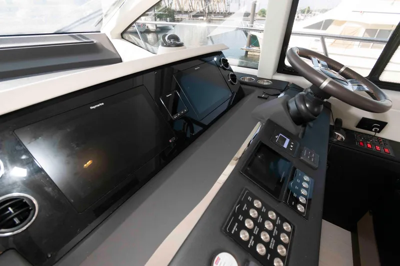 Slide: The Image of Cockpit of 2022 Azimut Fly 50 yacht with advanced navigation controls and steering wheel. - 30