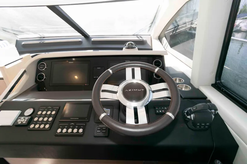 Slide: The Image of 2022 Azimut Fly 50 yacht helm with modern controls and steering wheel. - 31