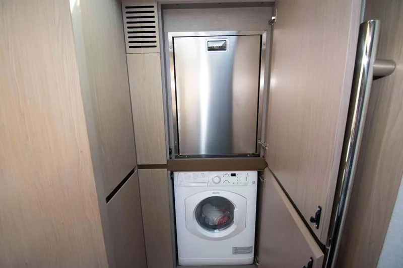 Slide: The Image of Laundry area in 2022 Azimut Fly 50 yacht with washer and storage. - 42