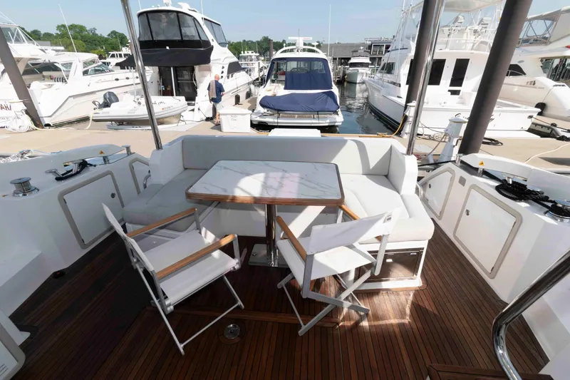 Slide: The Image of Azimut Fly 50 yacht deck with seating area, 2022 model, docked at marina. - 9