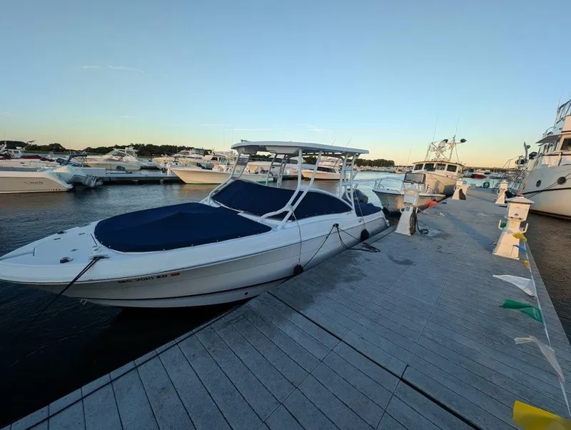 Slide: The Image of 2018 Robalo R247 Dual Console boat docked at marina during sunset. - 3