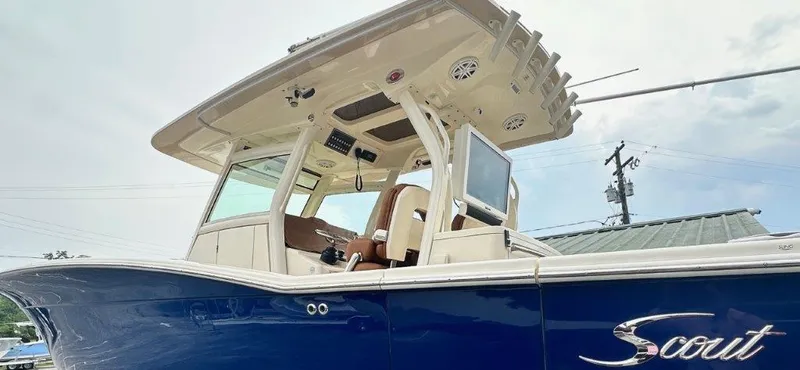 Slide: The Image of 2018 Scout 350 LXF boat with blue hull and modern cockpit design. - 1
