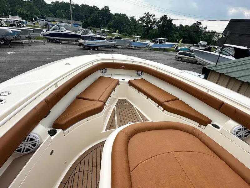 Slide: The Image of 2018 Scout 350 LXF boat with tan seating, docked in a marina. - 11