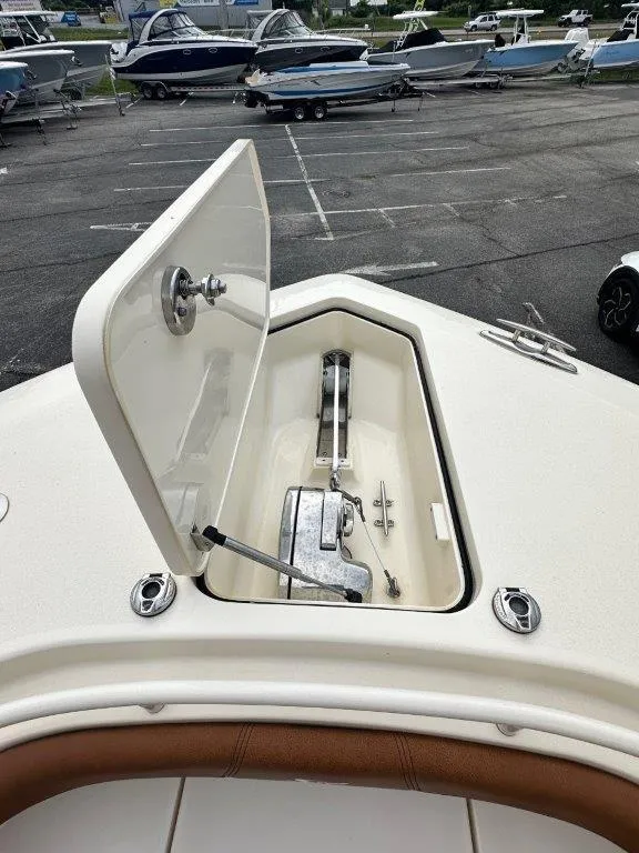 Slide: The Image of 2018 Scout 350 LXF boat anchor compartment open, showcasing storage and mechanism. - 12