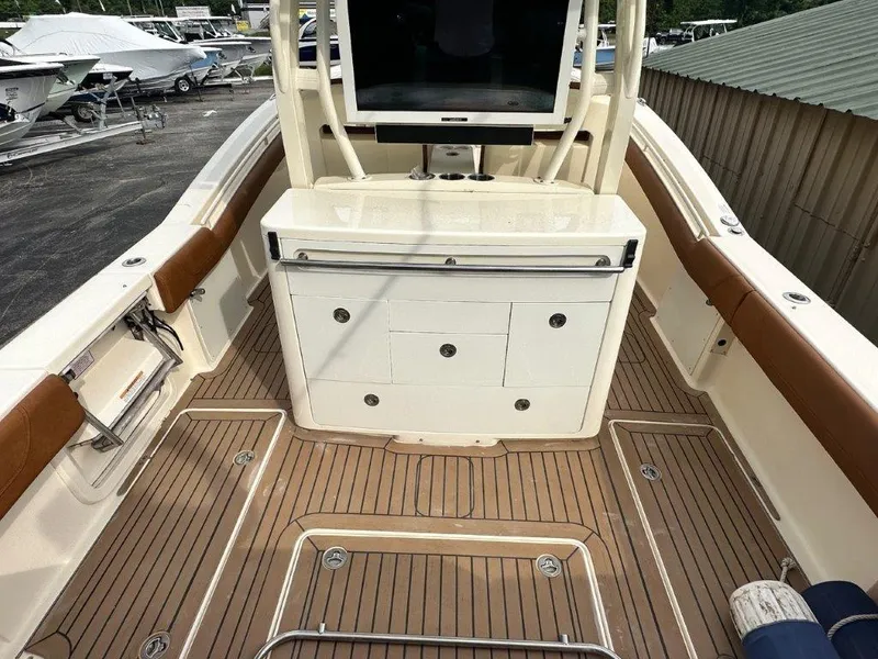 Slide: The Image of 2018 Scout 350 LXF boat interior with teak flooring and storage compartments. - 14