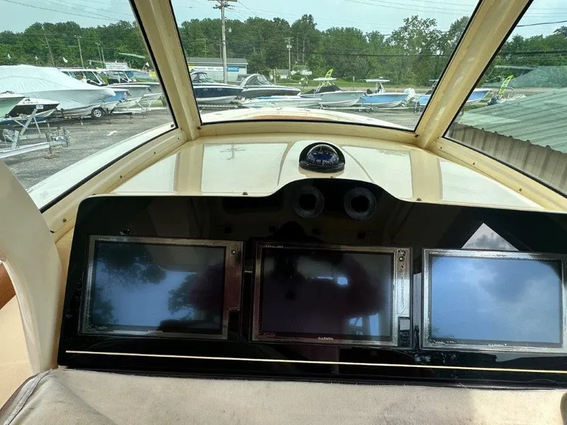 Slide: The Image of Cockpit of 2018 Scout 350 LXF boat with navigation screens and compass. - 18