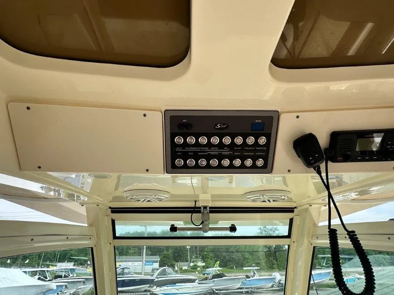 Slide: The Image of Interior view of 2018 Scout 350 LXF boat dashboard with control panel and radio. - 19